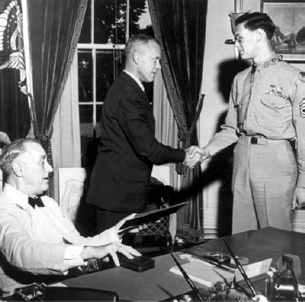Army Air Corps Tech. Sgt. Forrest L. Vosler is awarded the Medal of Honor from President Franklin Delano Roosevelt during a White House ceremony, Aug. 30, 1944. Shaking Vosler’s hand is Undersecretary of War Robert Porter Patterson Sr. Courtesy: U.S. Air Force